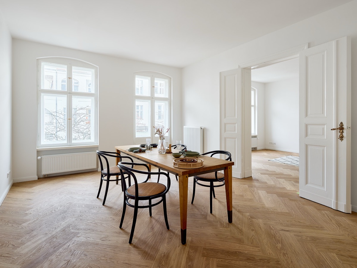 Esszimmer mit Rundbogenfenstern und Fischgrätparkett